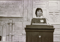 <span itemprop="name">An unidentified woman speaking during an event...</span>