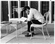 <span itemprop="name">An unidentified student reading a book on the...</span>