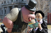 <span itemprop="name">An AFSCME activist dressed as "Monopoly Man" and...</span>