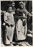 <span itemprop="name">An old woman standing with a boy and young woman....</span>