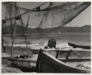 <span itemprop="name">A shore scene with a man working on a boat....</span>
