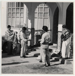 <span itemprop="name">Four men standing outside an entryway with shawls....</span>