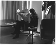 <span itemprop="name">An unidentified female student reading a newspaper...</span>