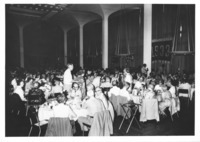 <span itemprop="name">People seated at tables attending the Class of...</span>
