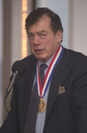 <span itemprop="name">An unidentified person speaking at the podium at...</span>