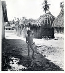 <span itemprop="name">Naked boy standing in the shadow of a housing...</span>