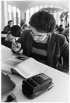 <span itemprop="name">An unidentified student doing homework in the...</span>