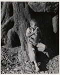 <span itemprop="name">Young boy leaning on a tree with a stick in his...</span>