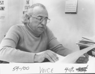 <span itemprop="name">Morris Budin seated at a desk working on material...</span>