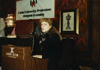 <span itemprop="name">An unidentified woman speaking from a podium...</span>