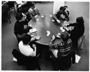 <span itemprop="name">A group of unidentified students playing a card...</span>