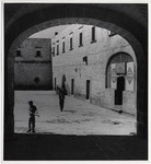 <span itemprop="name">Courtyard with two figures walking. A sign reads...</span>