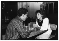 <span itemprop="name">An unidentified man and woman sitting at a table...</span>