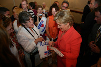 <span itemprop="name">Senator Hillary Clinton signs an autograph for a...</span>