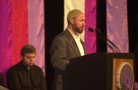 <span itemprop="name">An unidentified speaker addresses the crowd at a...</span>