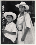 <span itemprop="name">A man and young boy wearing white shirts and hats...</span>