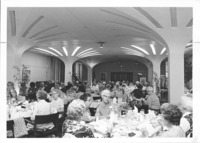 <span itemprop="name">People seated for a meal at an event associated...</span>