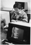 <span itemprop="name">An unidentified male student using a computer at...</span>