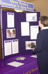 <span itemprop="name">An unidentified person examines a poster...</span>