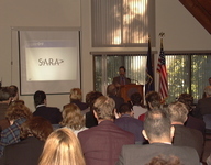 <span itemprop="name">Guests listen to a presentation by Dr. Alan...</span>