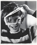 <span itemprop="name">A close up of a young boy wearing safety goggles,...</span>