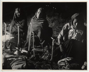 <span itemprop="name">Three women wrapped in shawls sitting on the...</span>