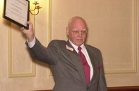 <span itemprop="name">An unidentified person hoists an award at the...</span>