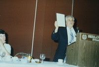 <span itemprop="name">Sam Wakshull speaking and holding a plaque during...</span>