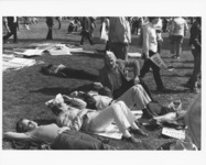 <span itemprop="name">Unidnetified people lounging on a lawn during...</span>
