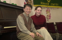 <span itemprop="name">Two unidentified persons pose on a piano bench at...</span>