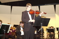 <span itemprop="name">A lone violinist rehearses for an orchestral...</span>