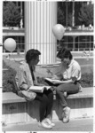 <span itemprop="name">Two unidentified students sitting and talking on...</span>