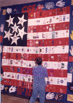 <span itemprop="name">A delegate admires an American flag quilt...</span>