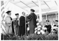 <span itemprop="name">An unidentified man receiving a doctoral degree...</span>