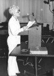 <span itemprop="name">An unidentified woman speaking at an event...</span>