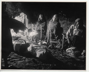 <span itemprop="name">Four women wrapped in shawls sitting on the ground...</span>