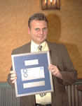 <span itemprop="name">Doug Andrey holds a plaque at the Sagamore...</span>
