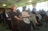 <span itemprop="name">The audience listens to the speakers at the...</span>