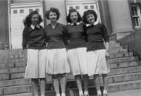 <span itemprop="name">Four female students standing together in front of...</span>