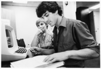 <span itemprop="name">Two unidentified students using a computer at the...</span>