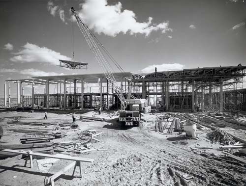 A crane lifts a portion of a building